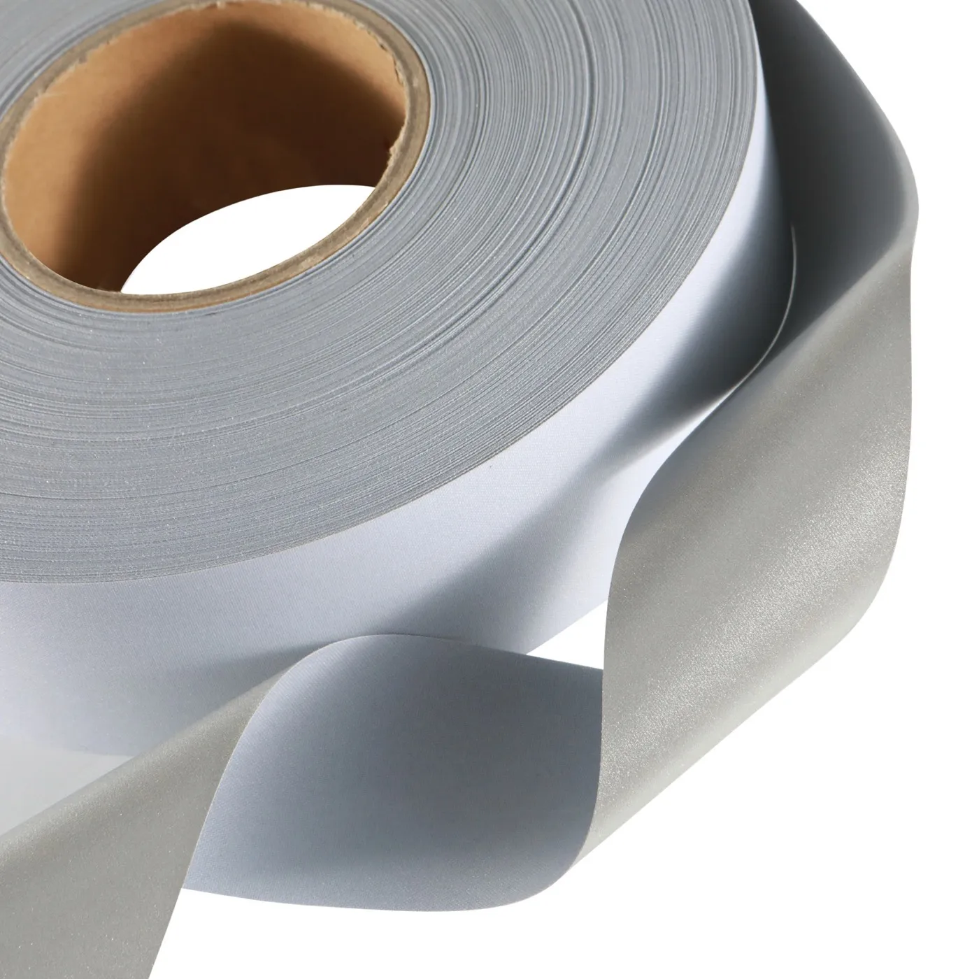 Industrial-wash reflective cloth roll, close crop on the silver coated surface and white backing